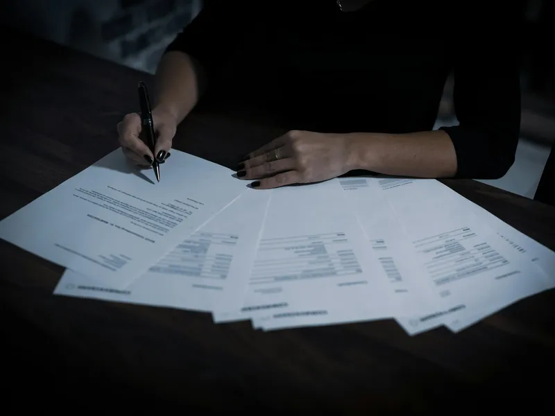 A researcher reviewing documents at a desk